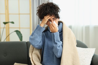 Cold symptom. Young woman with tissue at home