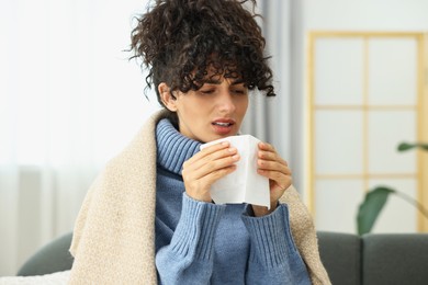 Cold symptom. Young woman with tissue at home