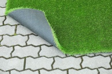 Photo of Sheet of green artificial turf in yard