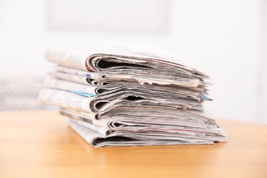 Photo of Stack of many newspapers on wooden table