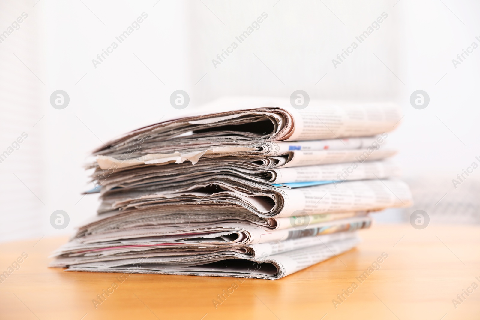 Photo of Stack of many newspapers on wooden table