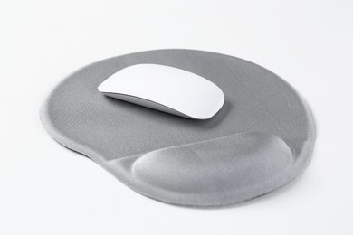 Photo of Mouse and mousepad with arm rest on white table, closeup