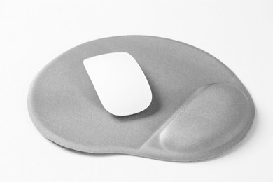 Photo of Mouse and mousepad with arm rest on white table, closeup