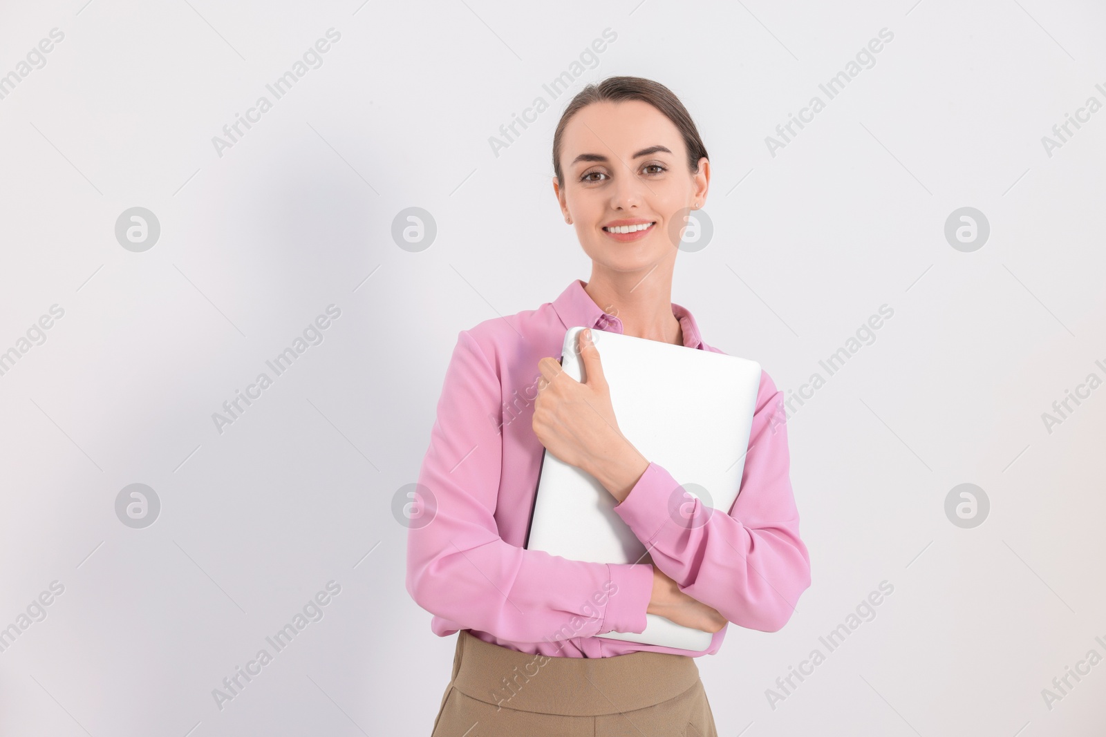 Photo of Portrait of smiling businesswoman with laptop on white background