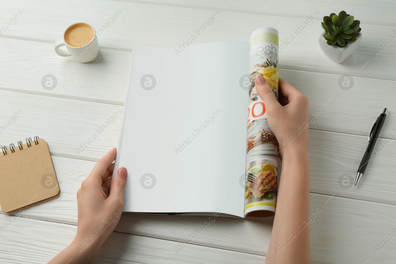 Photo of Woman reading magazine at white wooden table, closeup. Mockup for design