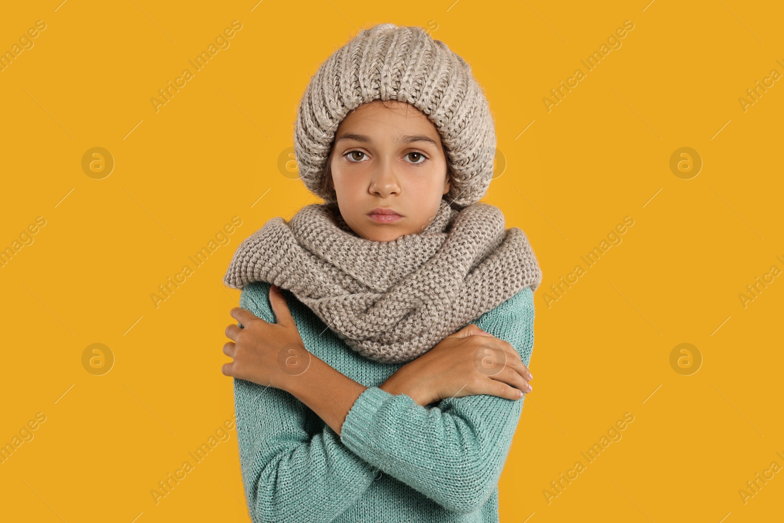 Photo of Cold symptom. Little girl suffering from fever on orange background