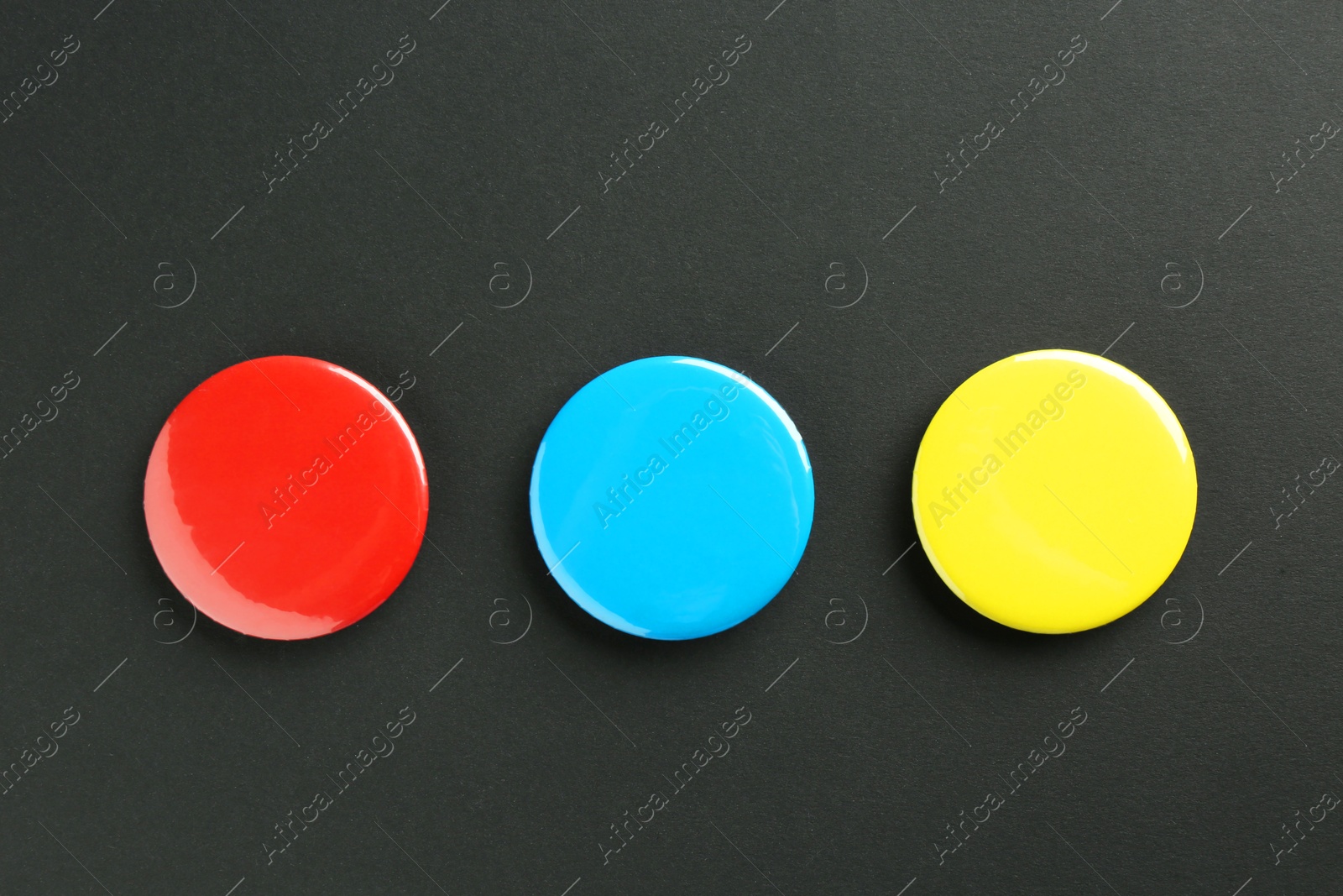 Photo of Button badges on black background, flat lay. Mockup for design