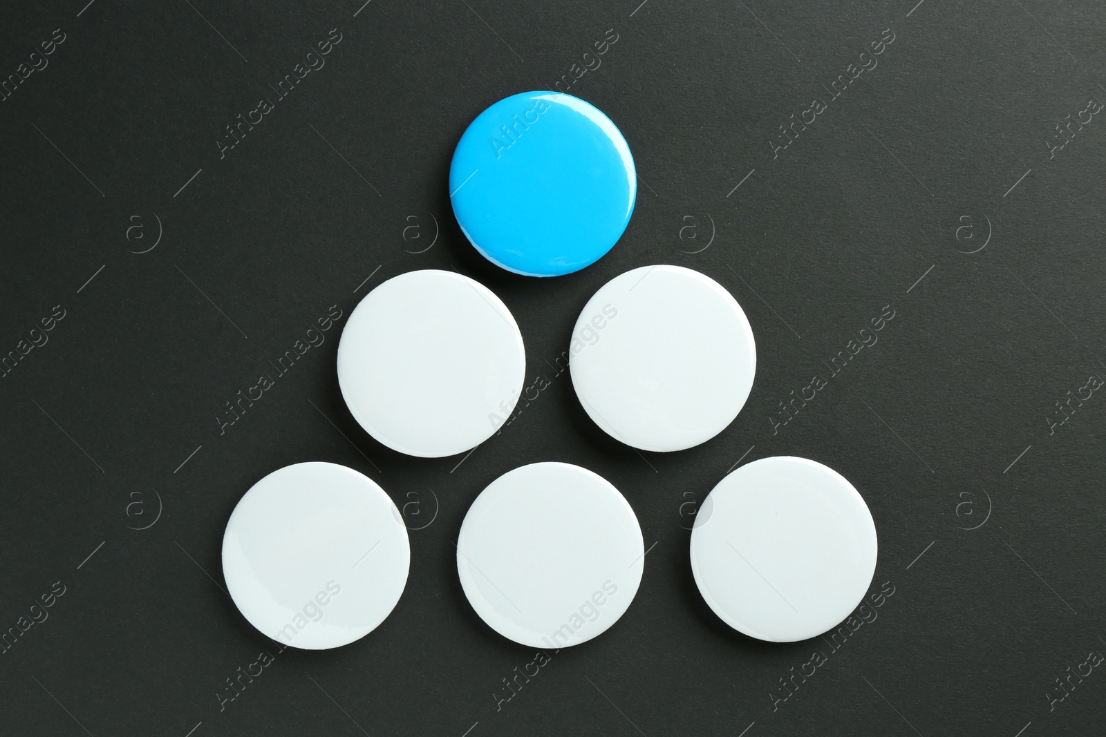 Photo of Button badges on black background, flat lay. Mockup for design