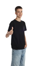 Photo of Teenage boy wearing black t-shirt and showing thumbs up on white background