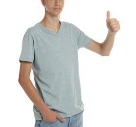 Photo of Teenage boy wearing light grey t-shirt and showing thumbs up on white background, closeup