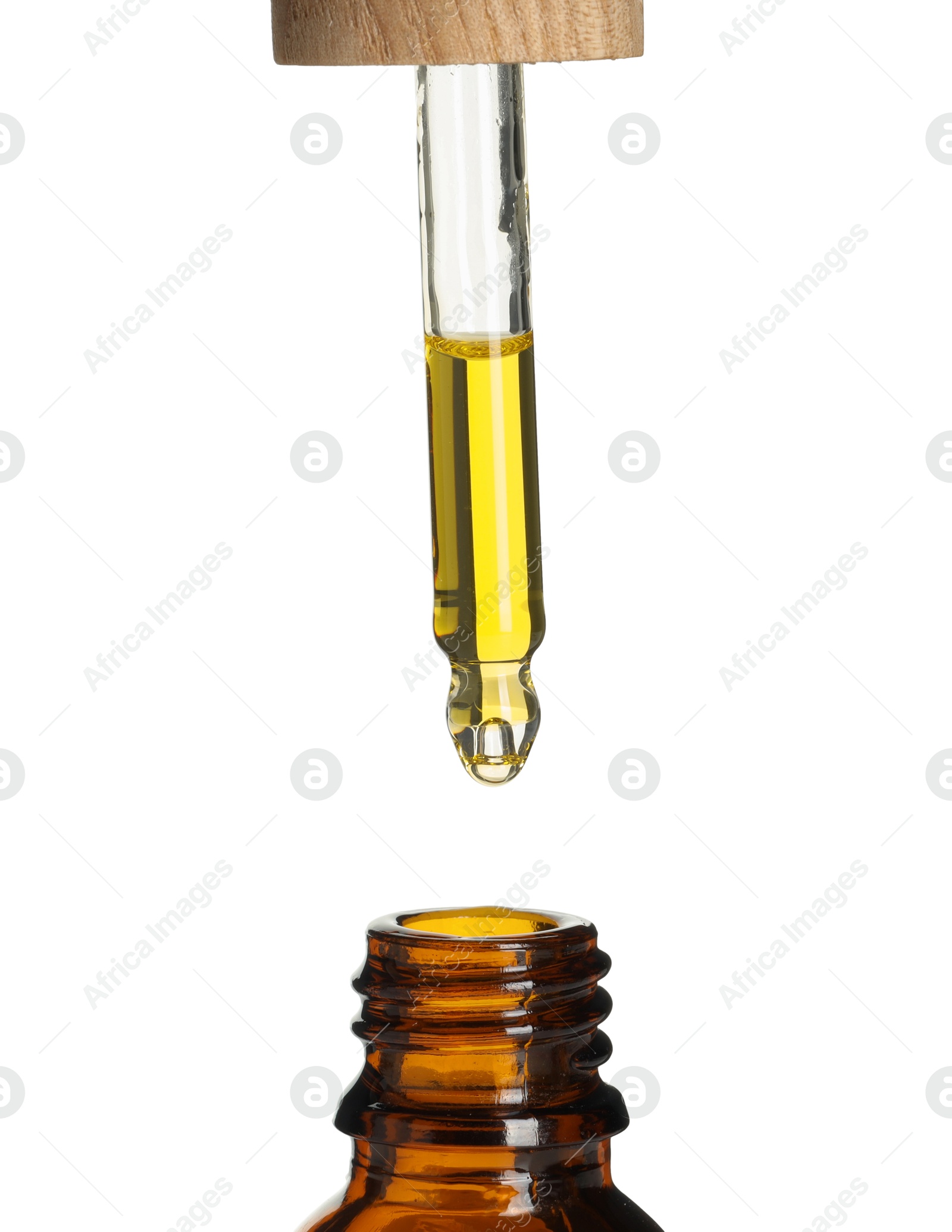 Photo of Dripping tincture from pipette into bottle on white background, closeup