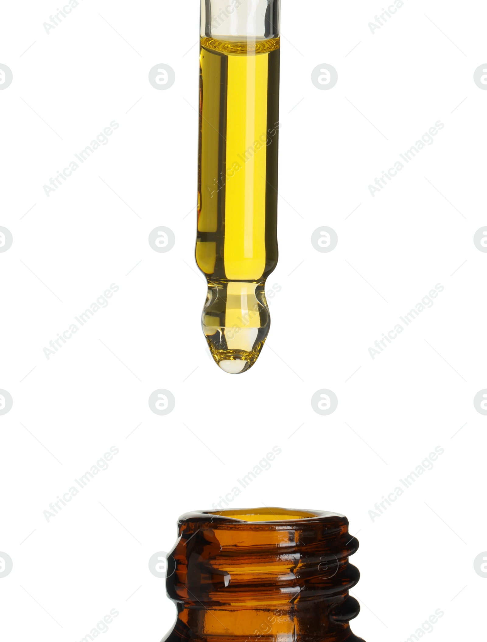 Photo of Dripping tincture from pipette into bottle on white background, closeup