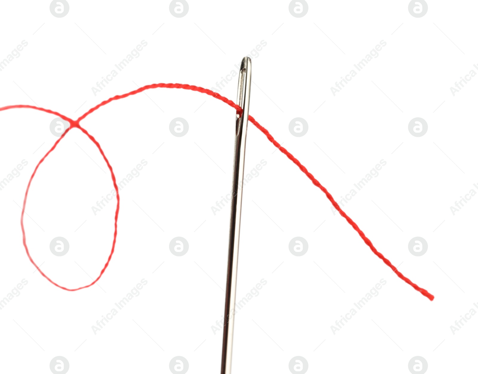 Photo of Sewing needle with red thread isolated on white