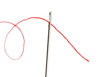 Photo of Sewing needle with red thread isolated on white