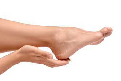 Photo of Woman touching her smooth feet on white background, closeup