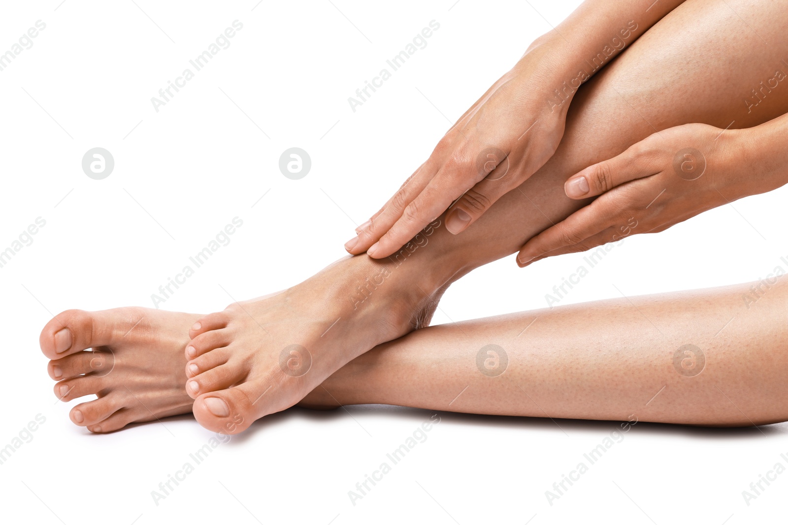 Photo of Woman touching her smooth legs on white background, closeup