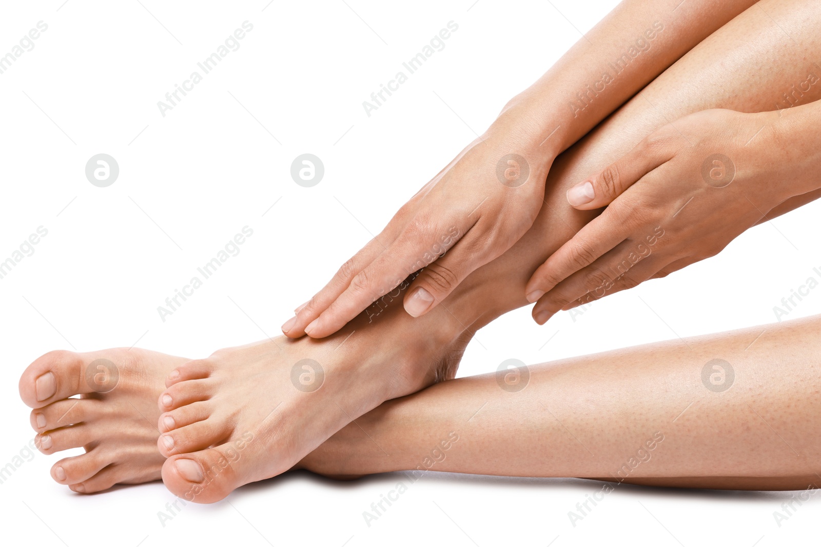 Photo of Woman touching her smooth legs on white background, closeup