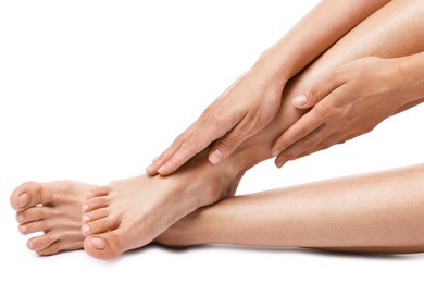 Photo of Woman touching her smooth legs on white background, closeup