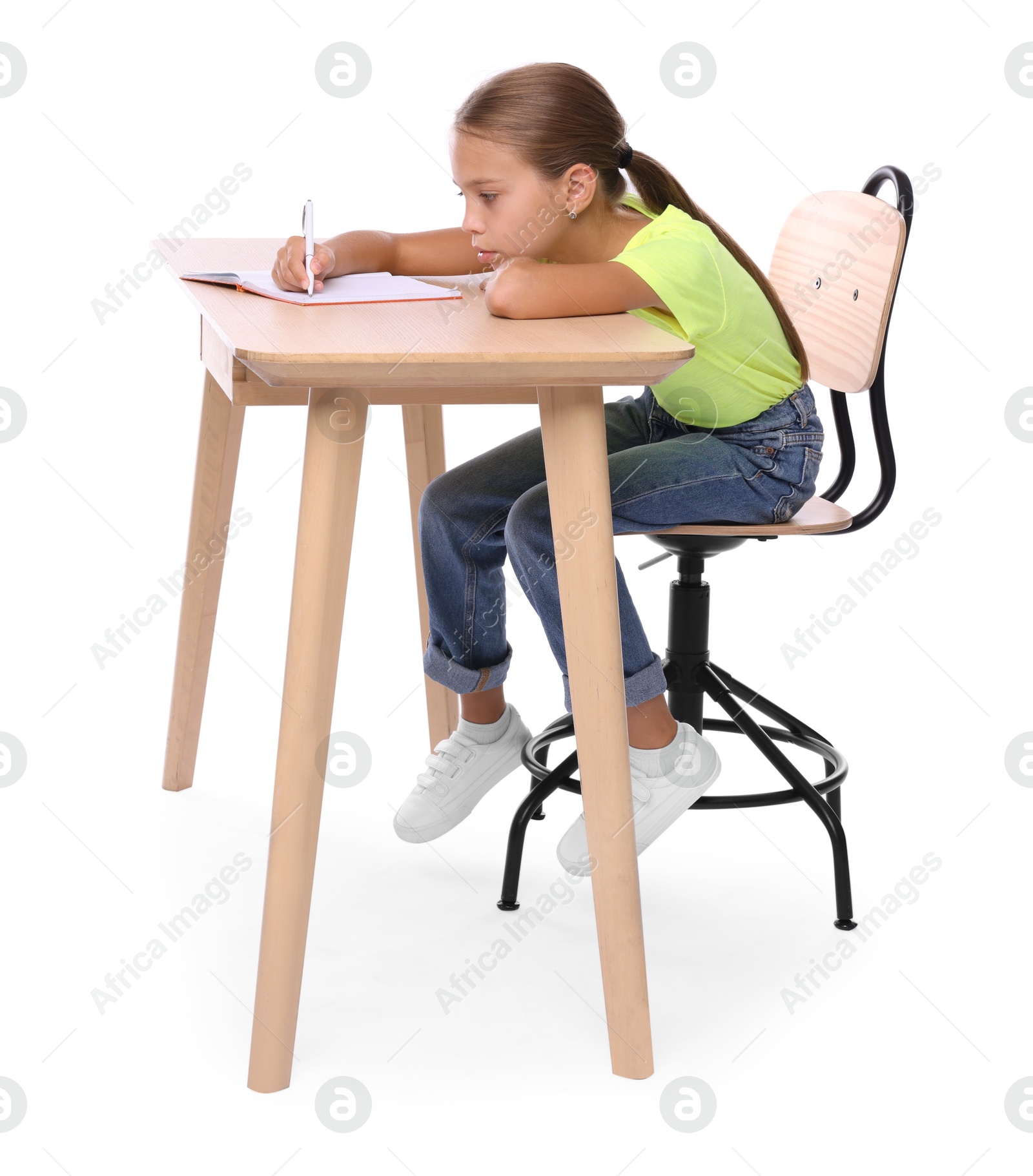 Photo of Girl with incorrect posture and notebook sitting at wooden desk on white background