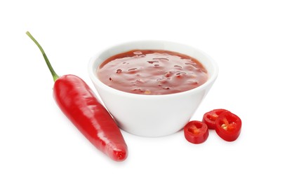 Photo of Hot chili sauce in bowl and pepper isolated on white