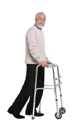 Senior man using walking frame on white background