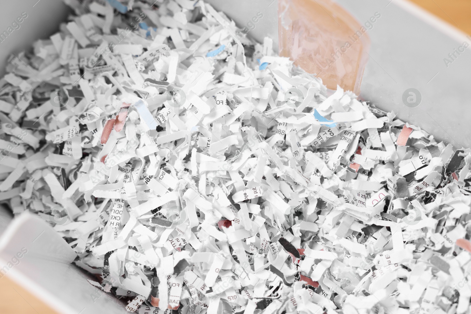 Photo of Shredded paper strips in bin, closeup view