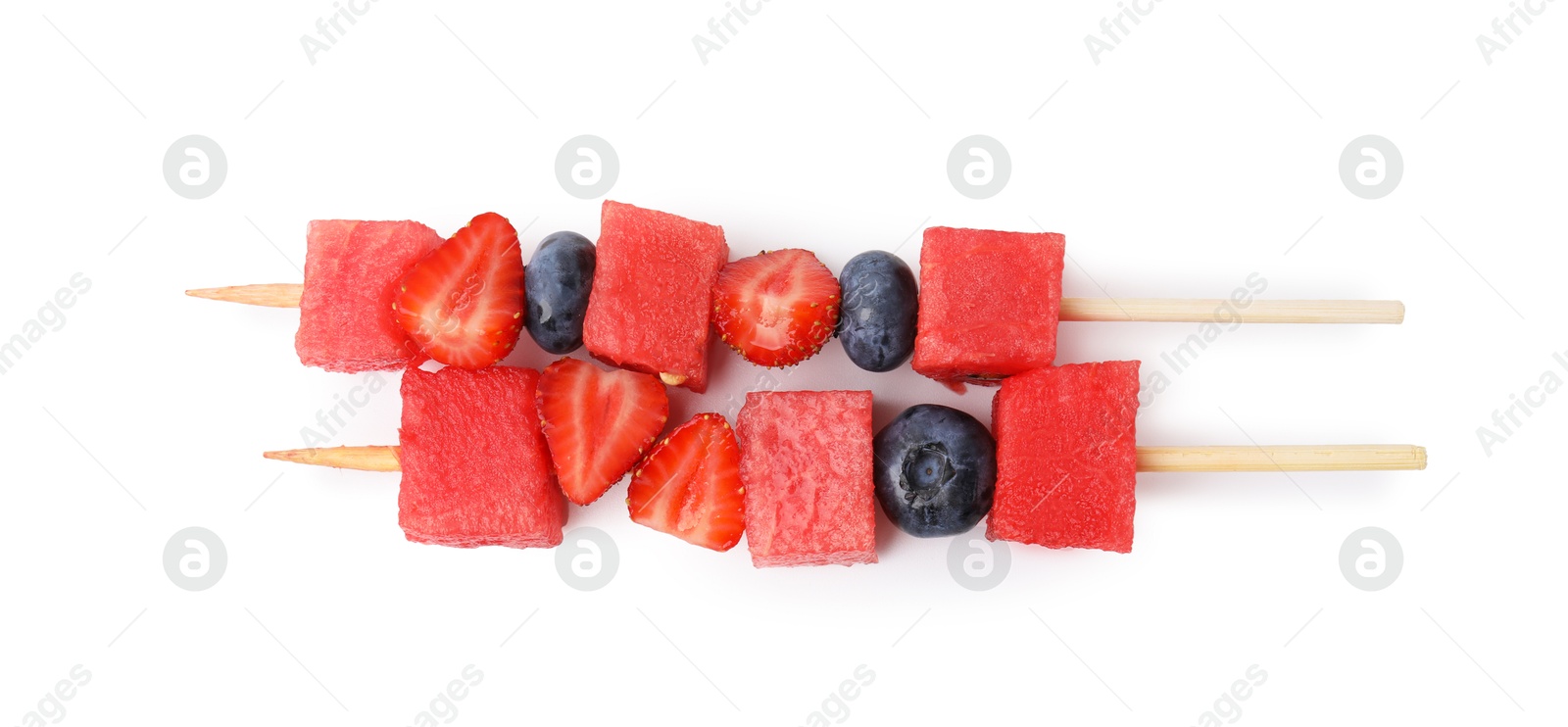 Photo of Skewers with tasty watermelon, blueberries and strawberries isolated on white, top view