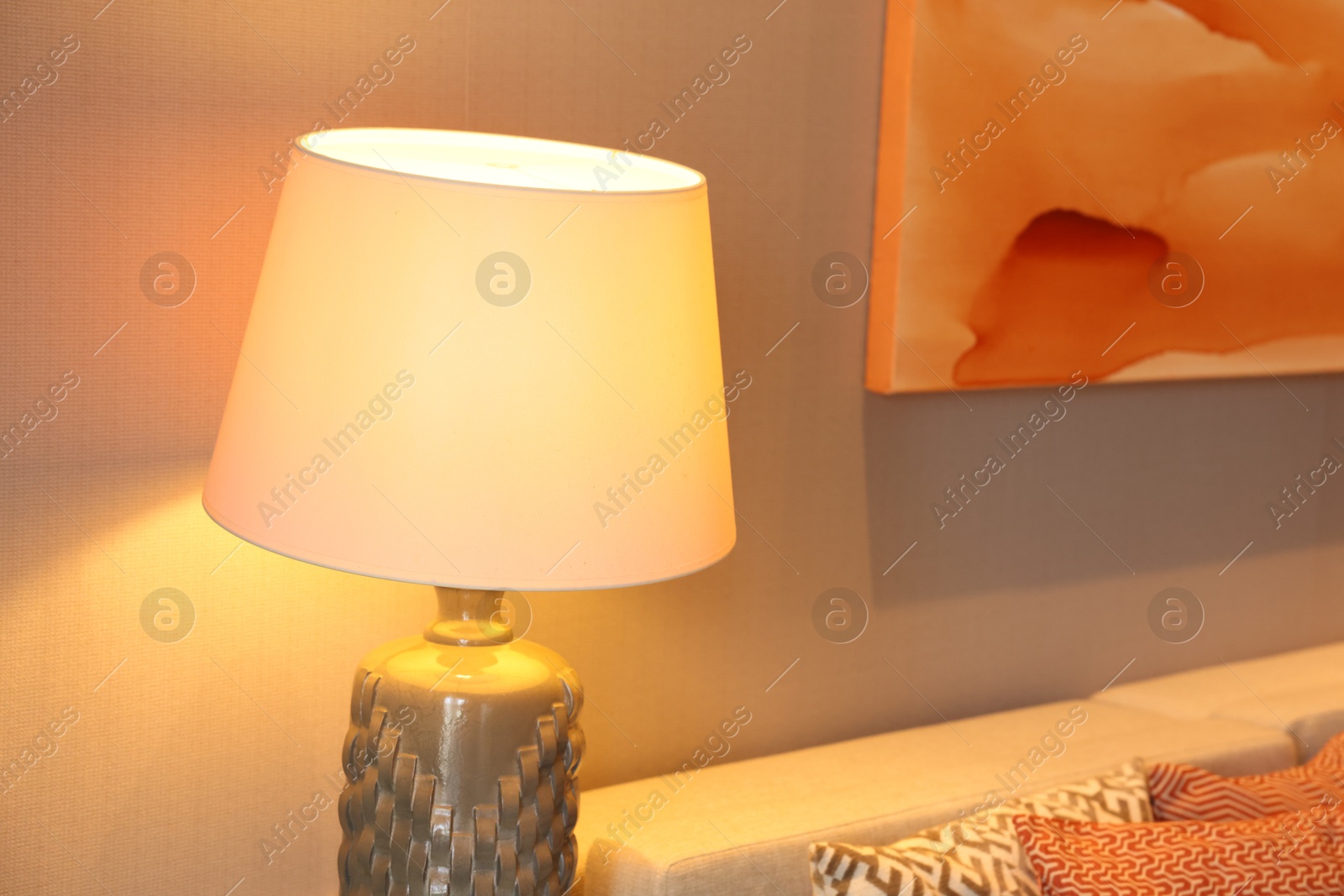 Photo of Stylish lamp near light wall in room, closeup