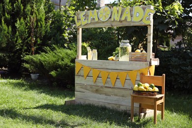 Photo of Lemonade stand with refreshing drink and fresh fruits in park