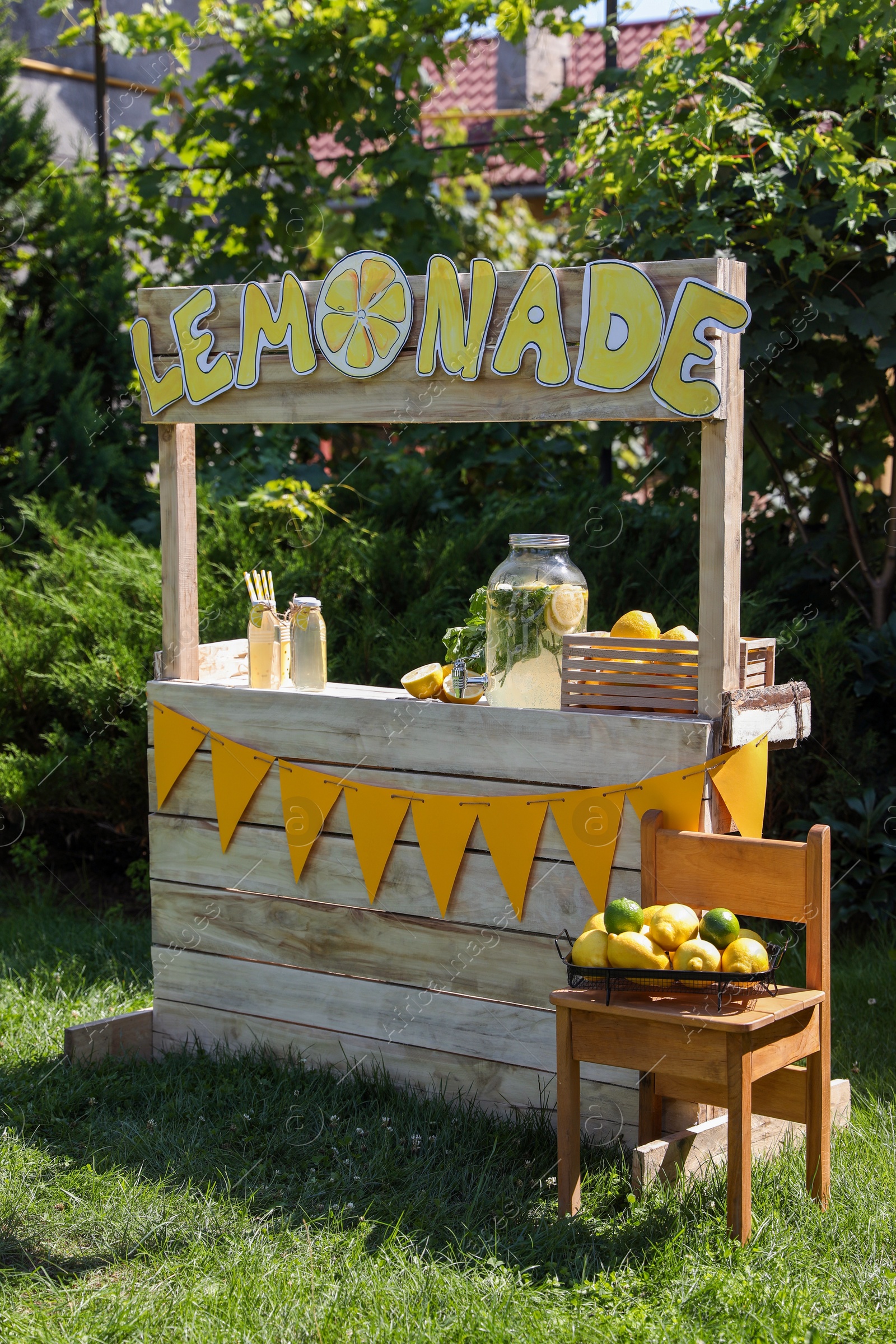 Photo of Lemonade stand with refreshing drink and fresh fruits in park