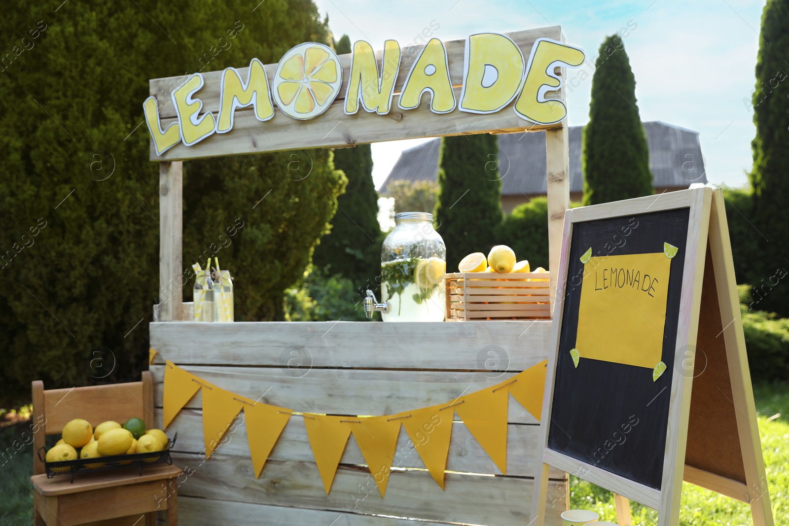 Photo of Lemonade stand with refreshing drink and fresh fruits in park