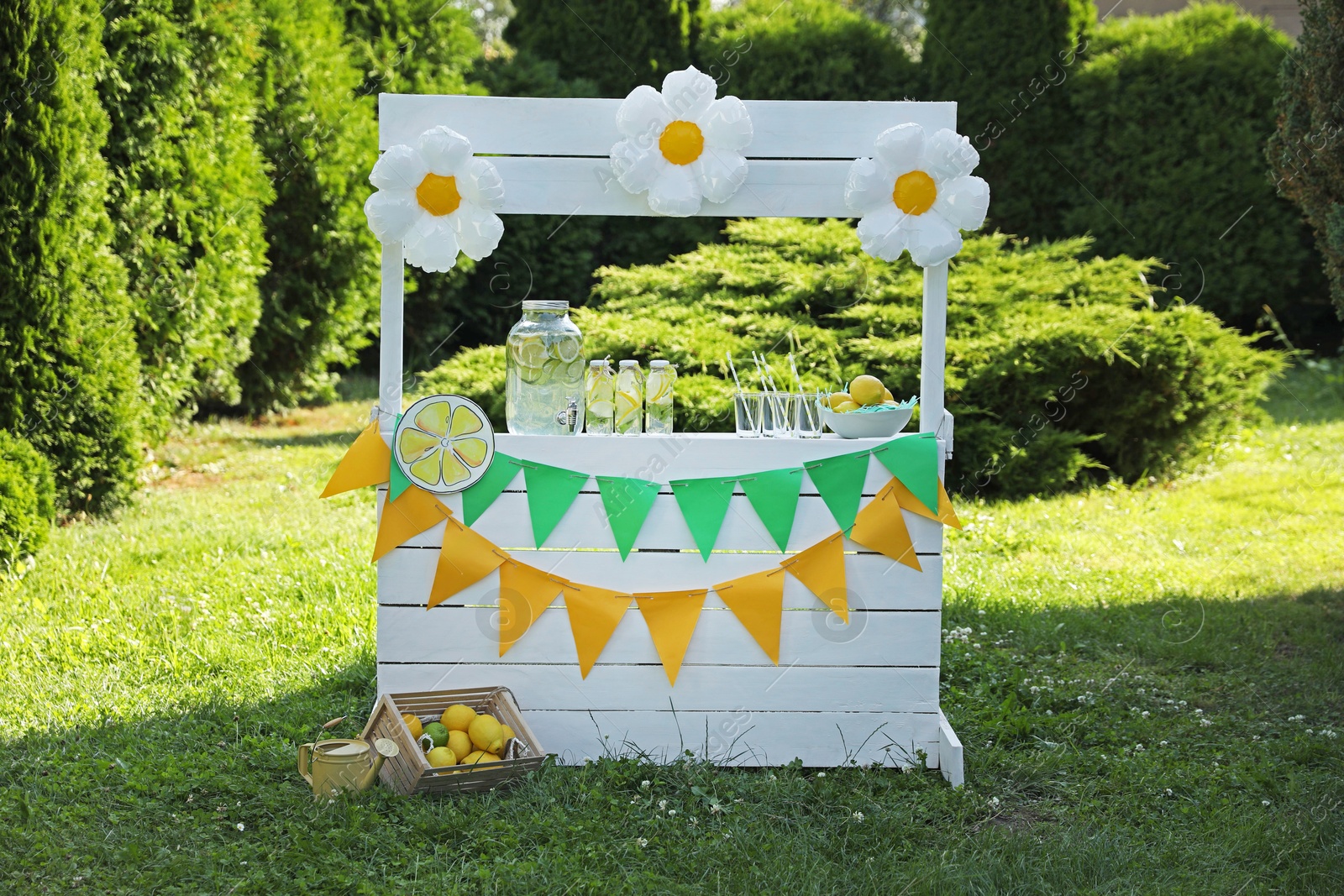 Photo of Lemonade stand with refreshing drink and fresh fruits in park