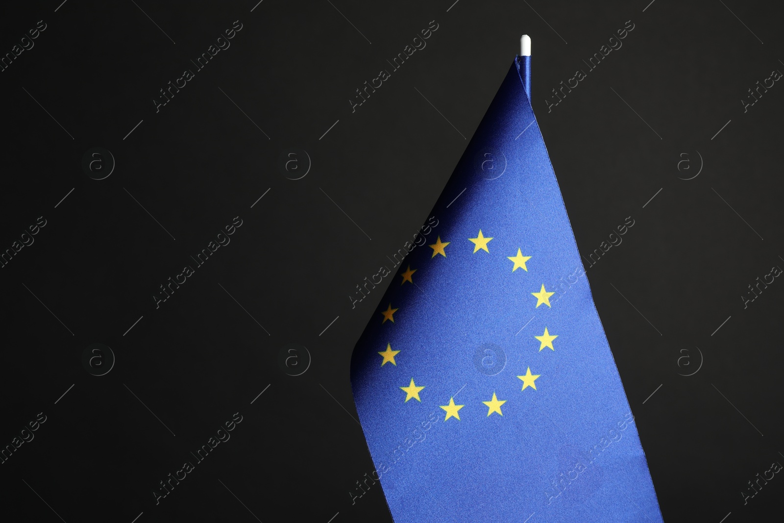 Photo of One flag of European Union on black background. Space for text