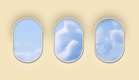 Image of Beautiful sky with clouds, view through airplane windows in beige sidewall of cabin