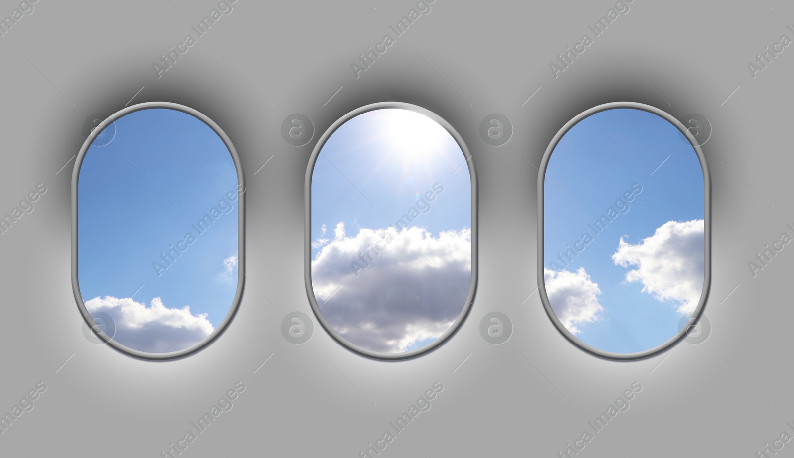 Image of Beautiful sky with clouds and sun, view through airplane windows in grey sidewall of cabin