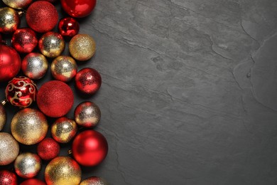 Photo of Different Christmas balls on grey textured background, flat lay. Space for text