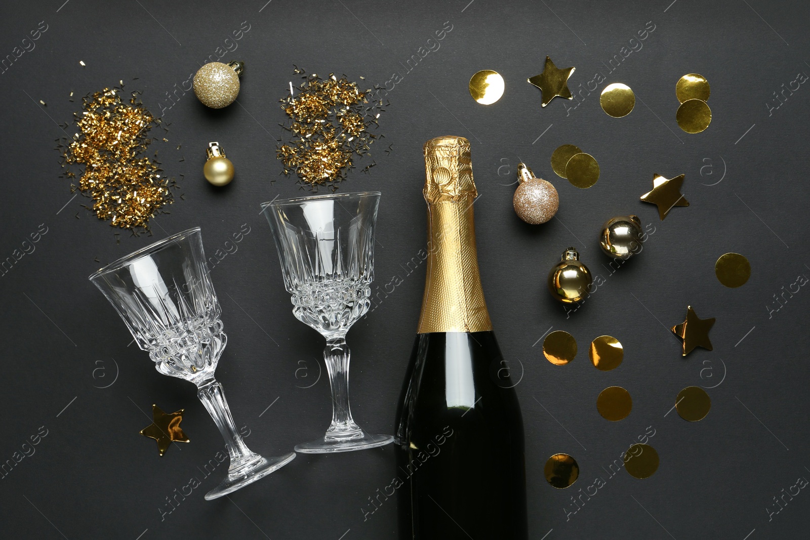 Photo of Flat lay composition with confetti and bottle of sparkling wine on grey background