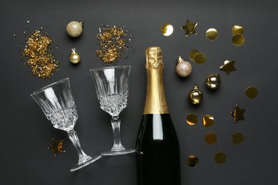 Photo of Flat lay composition with confetti and bottle of sparkling wine on grey background