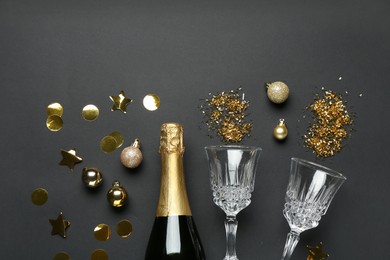 Photo of Flat lay composition with confetti and bottle of sparkling wine on grey background