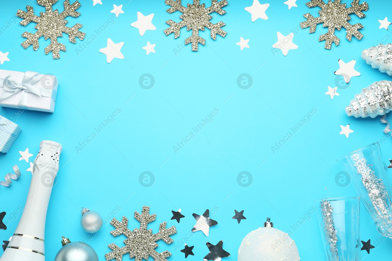 Photo of Flat lay composition with confetti and other Christmas decor on light blue background, space for text