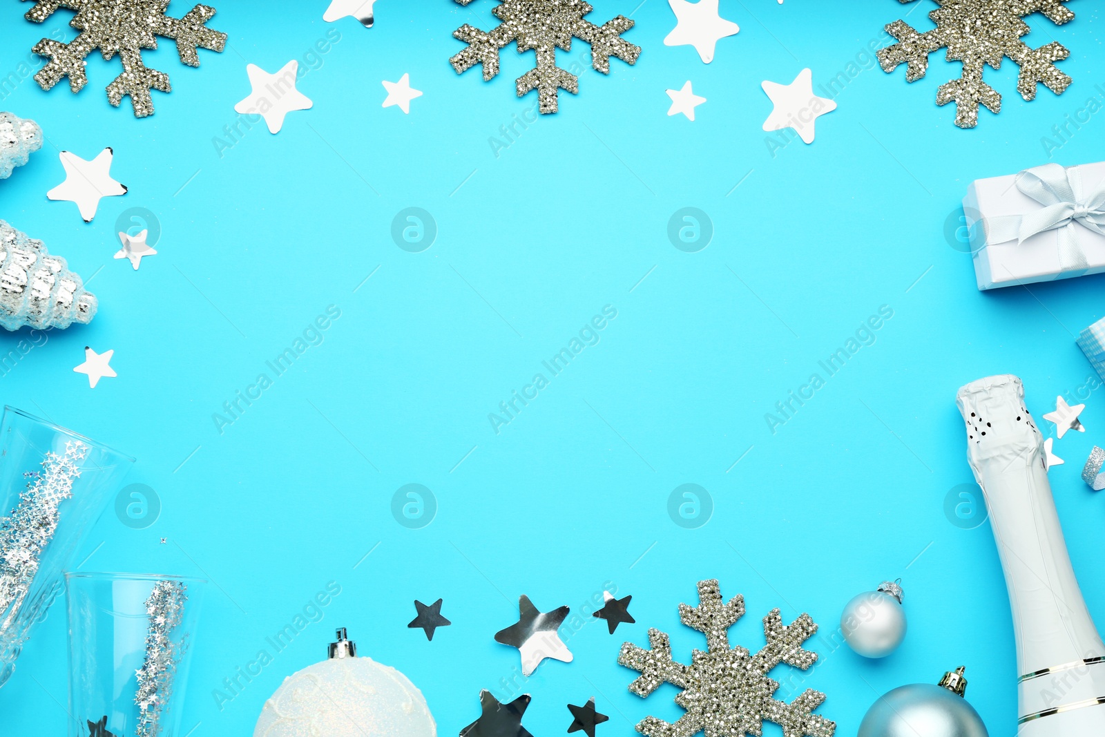 Photo of Flat lay composition with confetti and other Christmas decor on light blue background, space for text