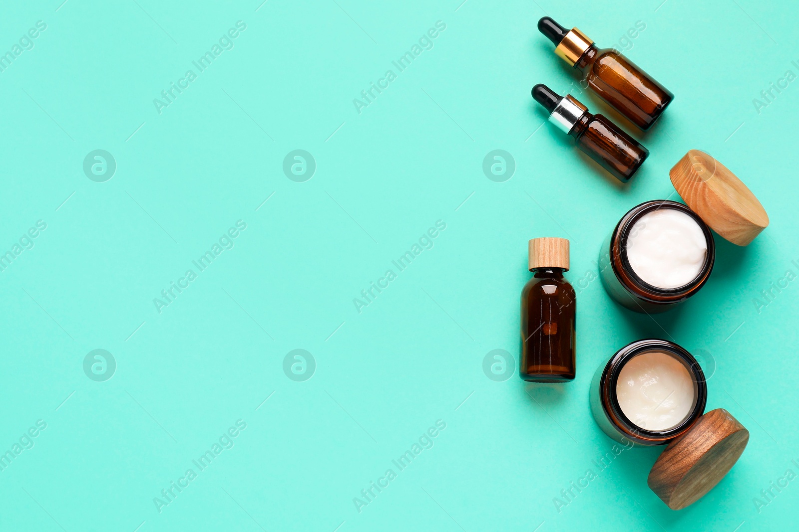 Photo of Different cosmetic products on turquoise background, flat lay. Space for text