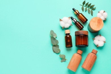 Photo of Different cosmetic products, leaves and cotton flowers on turquoise background, flat lay. Space for text