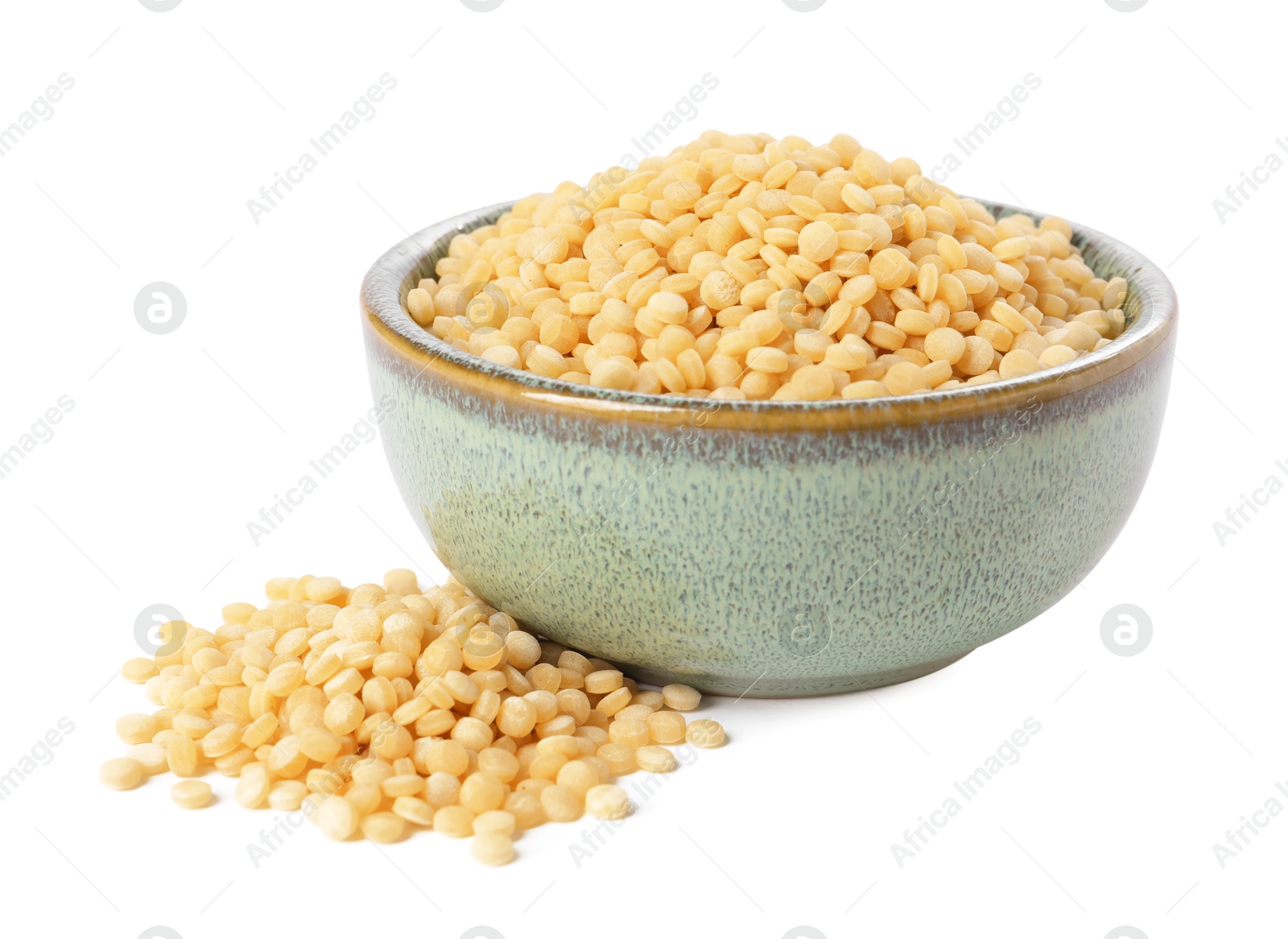 Photo of Raw couscous in bowl isolated on white