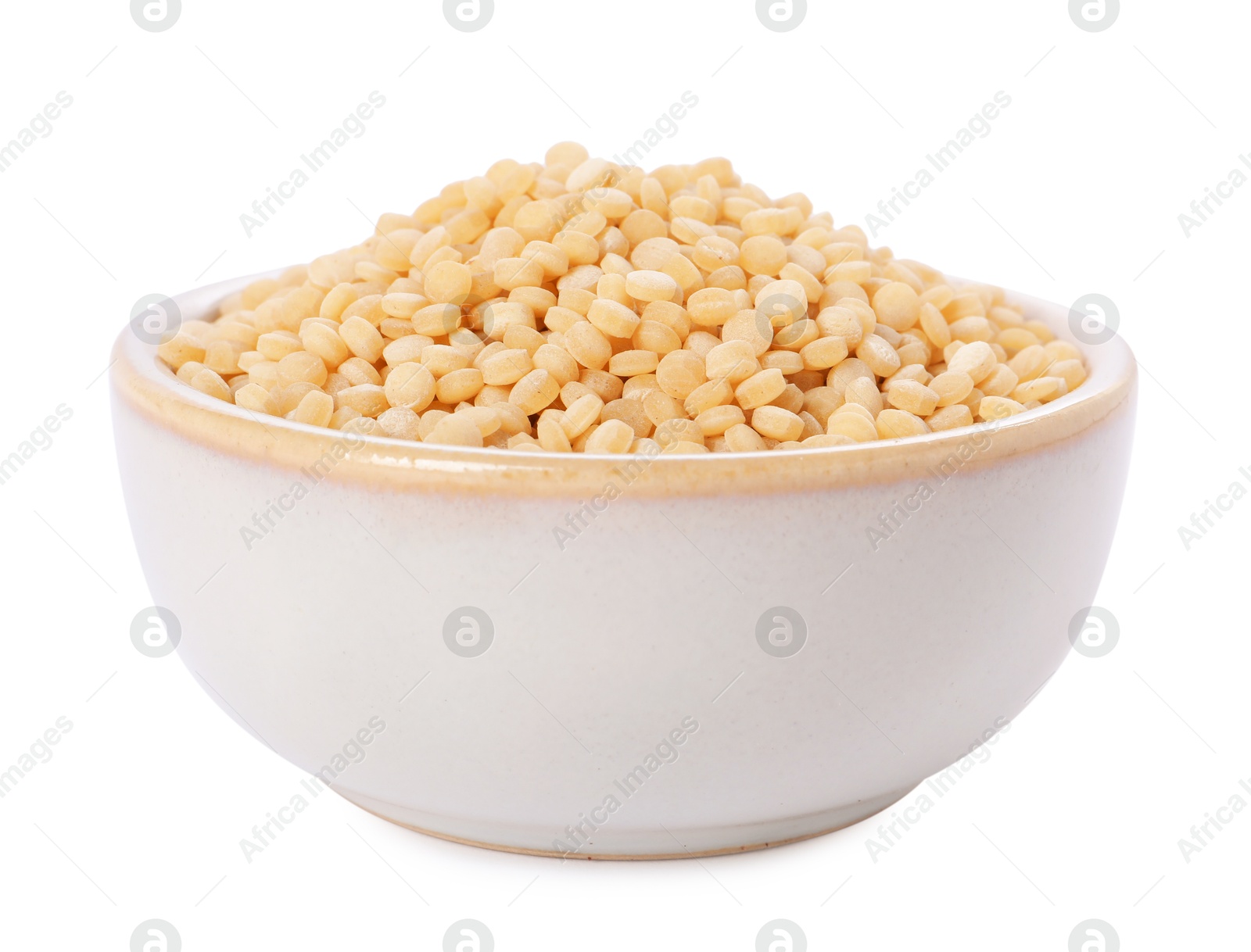 Photo of Raw couscous in bowl isolated on white