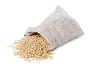 Photo of Raw couscous and overturned burlap sack isolated on white