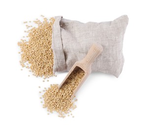 Photo of Raw couscous, overturned burlap sack and wooden scoop isolated on white, top view