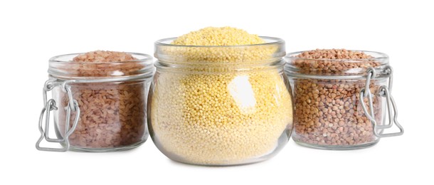 Photo of Different cereal grains in glass jars isolated on white