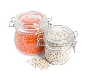 Photo of Raw beans and lentils in glass jars isolated on white