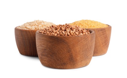 Photo of Different cereal grains in wooden bowls isolated on white